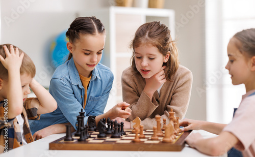 Kids learning to play chess together