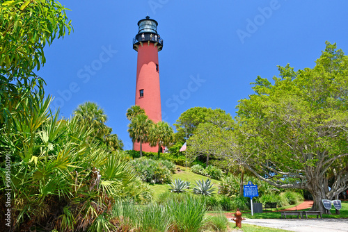Old, historic lighthouse in Jupiter, Florida surrounded by lush green vegetation