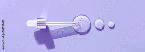 pipette drop of serum test on a purpule background 