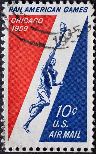 UNITED STATES - CIRCA 1959: a postage stamp from UNITED STATES , showing einen Runner Holding Torch. Pan American Games - Chicago 1959 . Circa 1959