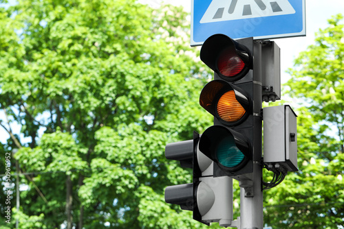 Post with traffic lights and Pedestrian Crossing road sign outdoors