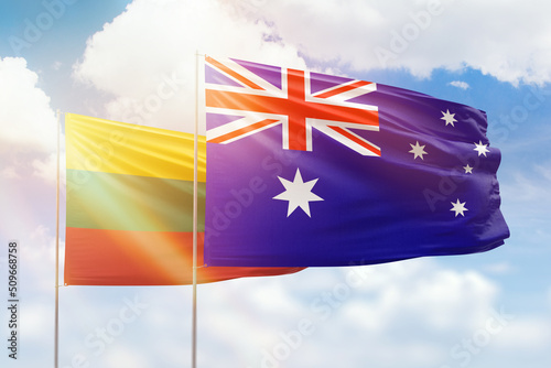 Sunny blue sky and flags of australia and lithuania