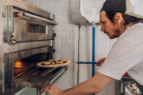Portrait of a kitchen chef working in a pizza place