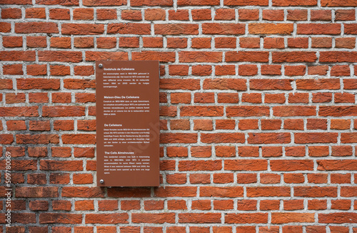 Mechelen, Antwerp Province, Belgium -Sign of the Cells Almhouses on a brick stone wall