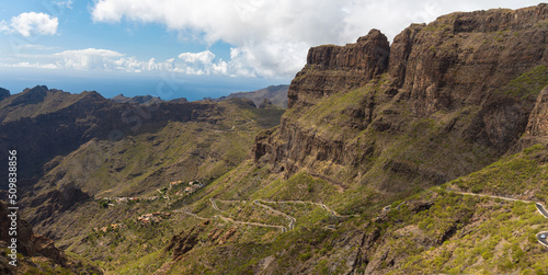 Curvy roads in Masca valley leading to Masca village. Scenic mountain landscape in the Macizo de Teno mountains. Ocean in the background. Buenavista del Norte, Santa Cruz de Tenerife, Tenerife.