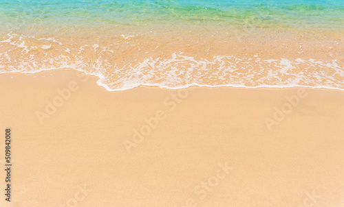 Sand beach seaside on summer season tropical with white foamy and blue wave from the sea on day light well editing text promote tourism project background 