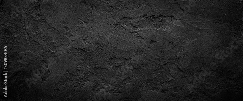 Black or dark gray rough grainy stone texture background