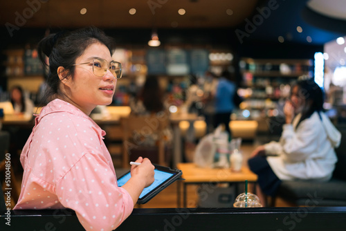 relax leisure attractive smart asian female freelance entrepreneur smile and enjoy working with smartphone and laptop tablet at cafe restaurant digital nomad expat casual ideas work anywhere concept