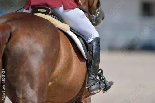 The rider on horseback overcomes the obstacle during the equestrian event