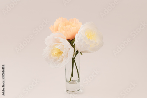 Bouquet of crepe paper peonies in a vase on white background. Paper peony DIY concept