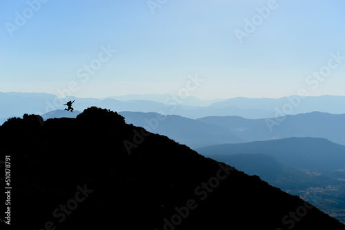 Jumping of an energetic, enthusiastic and dynamic person in the summit mountains
