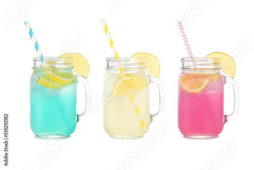 Cold, colorful summer lemonade drinks. Blue, yellow and pink colors in mason jar glasses isolated on a white background.