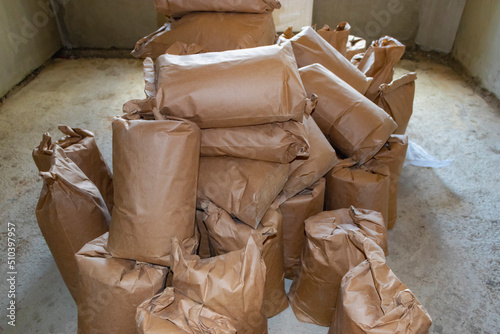 Cement bagBuilding mix bags. Delivery of cement and plaster for works. Paper bags with cement and building mixtures. Storage of materials at the construction site.