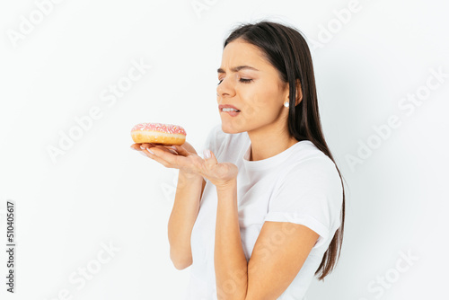 Portrait of young woman resist to eat junk food