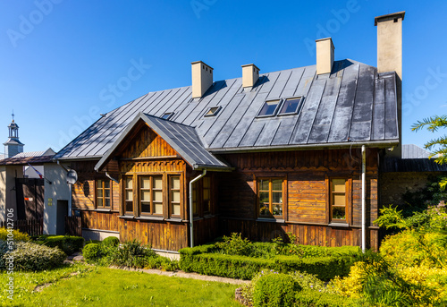 Reconstructed wooden country house aside St. Catherine Benedictine convent in Swieta Katarzyna village in Swietokrzyskie Mountains in Poland