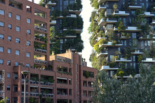 Skyscraper apartment buildings with green oases on the balconies, vertical forest.