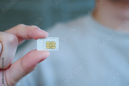 Man hand holding white sim card. Technology concept.