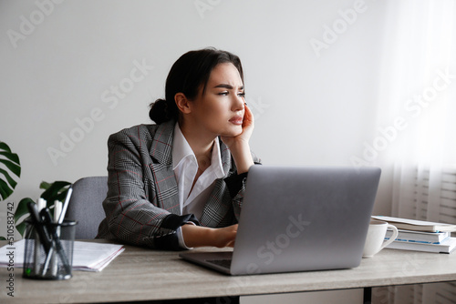 Portrait of a young businesswoman in a state of emotional, physical and mental exhaustion caused by excessive work related stress. Professional burnout concept. Close up, copy space, background.