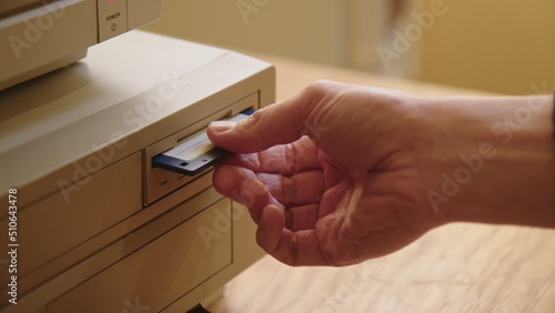Hand inserting and ejecting Floppy Disk into vintage Commodore Amiga 2000 PC