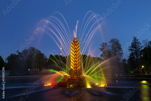 Fountain "Zolotoy Kolos" ("Golden spike") on the territory of the All-Russian exhibition center (VDNH) in the evening. Moscow, Russia
