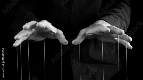 Man hands with strings on fingers. Violence, harassment, bullying concept. Master, abuser using influence to control person behavior. High quality photo