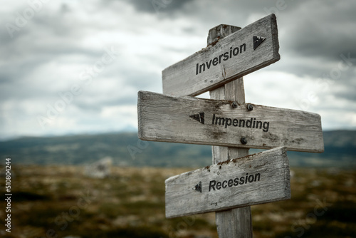 inversion impending recession text quote on wooden signpost outdoors in nature. Inflation, economy and finance concept.