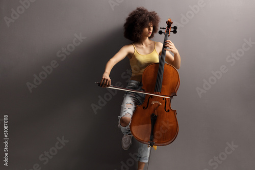 Young female artist playing a cello