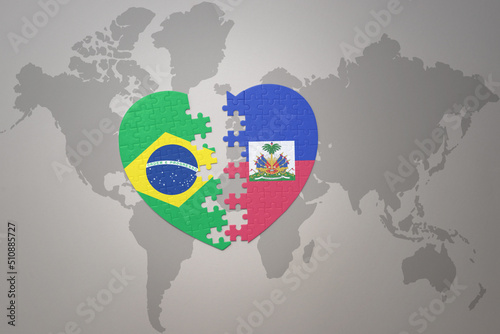 puzzle heart with the national flag of brazil and haiti on a world map background.Concept.