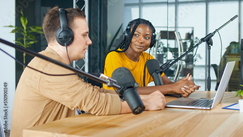 A Male Presenter Communicates with a Guest, an African American, During a Radio Broadcast at a Table in a Recording Studio, Broadcasts a Live Radio Interview With Spbd.