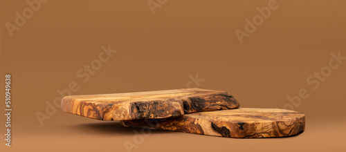Wooden podium for cosmetic products, perfumes or food against beige background. Front view. 