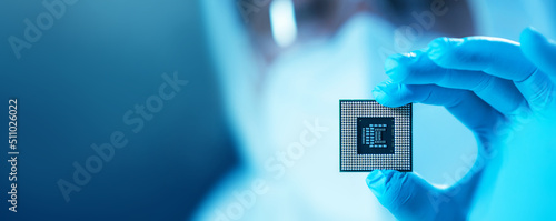 The scientist works in a modern scientific laboratory for the research and development of microelectronics and processors. Microprocessor manufacturing worker uses computer technology and equipment.