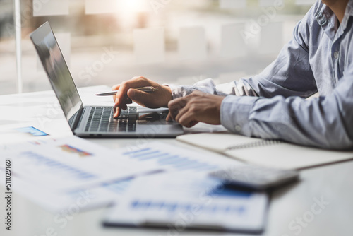 Modern business accountants are using laptops to check financial transactions using laptop software. Accounting concept tax and financial system.