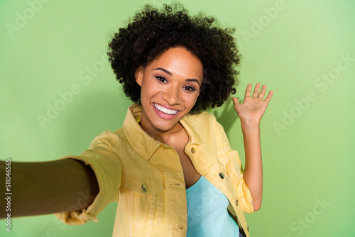 Photo of shiny cute woman dressed yellow jeans jacket recording self video arm empty space isolated green color background