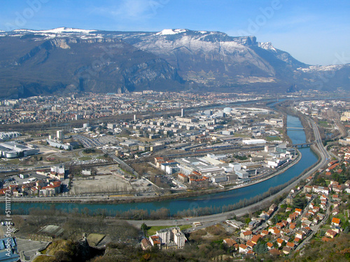 Grenoble. View of the city from above from a great height from the Bastille fortress. Mountains with snow, Isere river, roofs of houses, roads. France 2009 