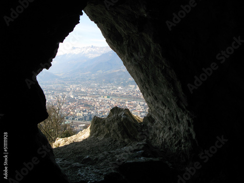 Grenoble, Bastille fortress. View of the city from Mandrin Cave. The view from the dark cave at a height outward to the city far below. Ancient caves. France 2009