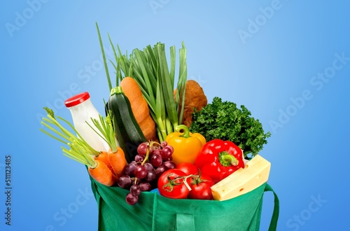 Shopping bag full of fresh groceries, grocery shopping concept on background
