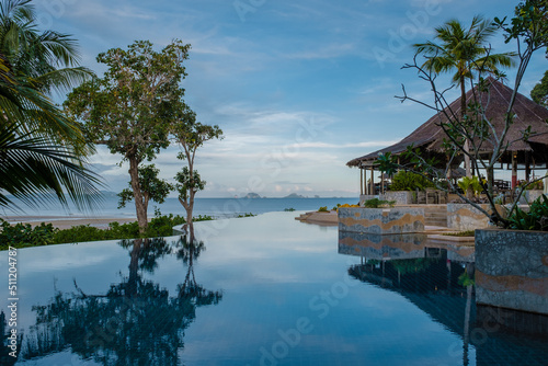 A luxury resort in Thailand with a swimming pool looking out over the ocean of Phangnga Kho Yao Yai. 