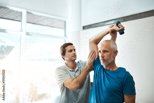 These exercises are very important for your recovery. Shot of a young male physiotherapist helping a client with stretching exercises in his office during the day.