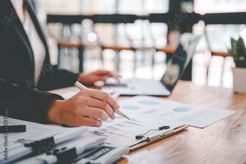 Portrait of a woman working on a tablet computer in a modern office. Make an account analysis report. real estate investment information financial and tax system concepts