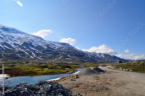 Snowy mountains with an ice lake below Dalsnibba hill in the Romsdal region of Norway