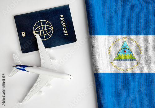 Flag of Nicaragua with passport and toy airplane. Flight travel concept 