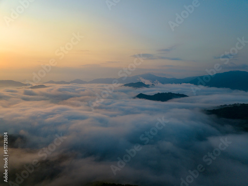 Sunrise over sea of clouds and mountain peaks