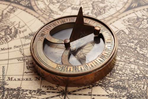 Vintage compass with sundial on old map. Adventure retro style