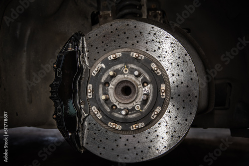 Massive brake caliper on carbon brake disk on a performance car