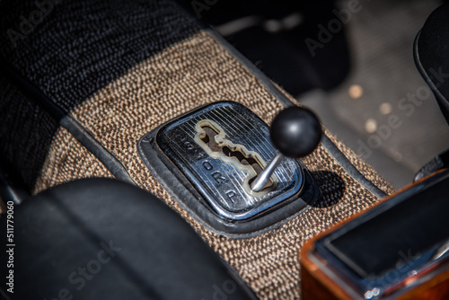 Close up horizontal shot of the gear shifter of a vintage car.