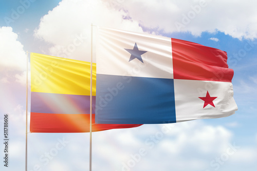 Sunny blue sky and flags of panama and colombia