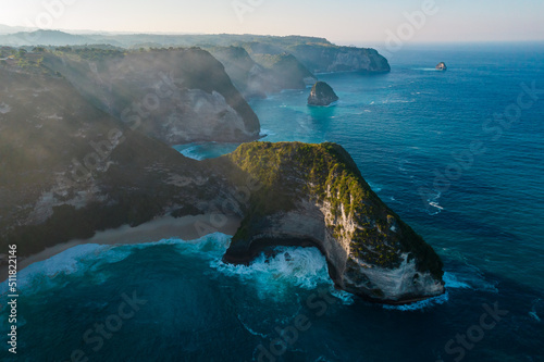 Aerial drone shot panoramic view of rocky beach with cliff. Indian ocean shore. Copy space for text. Nature and travel background. Beautiful natural summer vacation travel concept.