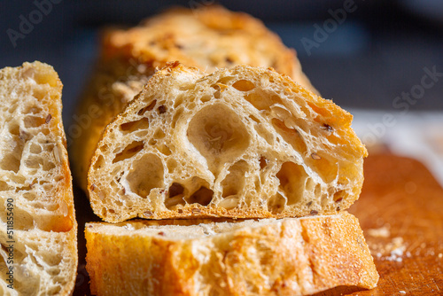 Bread macro. Bread pores. Fresh baguette with grains macro.Bakery advertisement. Seeds in bread. Freshly baked bread. French baguette cut. Fresh bakery. Bun in a cut. Baking from the oven. Bakery