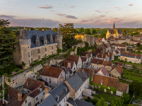 Aerial sunset view of Montresor medieval castle with a Renaissance mansion in Indre et Loire, on a rocky overhand dominating the valley, on of the most beautiful villages of France