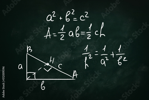 Basic triangle area formulas and Pythagorean theorem written on chalkboard